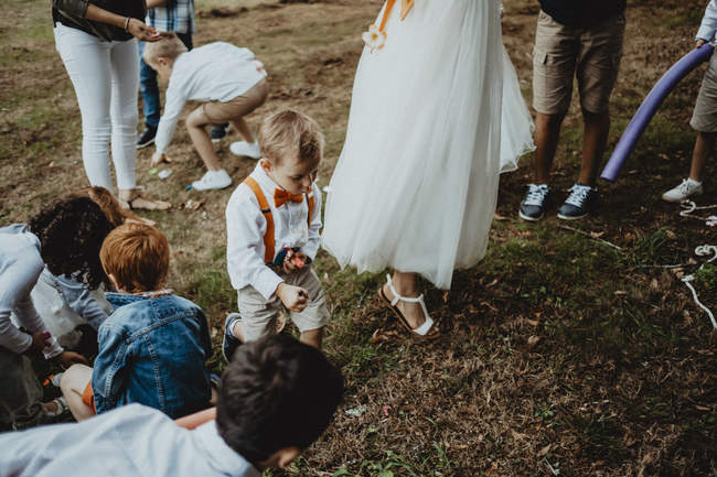 les enfants du mariage jouent sous les yeux du photographe
